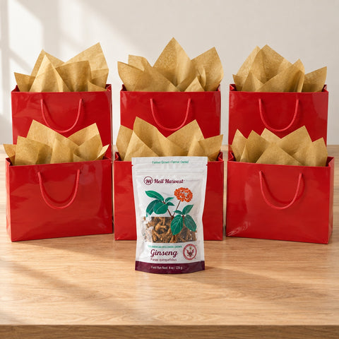 Six red gift bags with gold tissue and an 8 oz Heil Harvest ginseng pouch