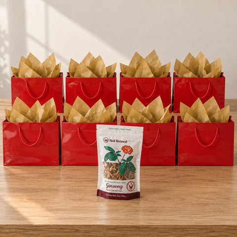 Eight red gift bags with gold tissue and an 8 oz Heil Harvest ginseng pouch