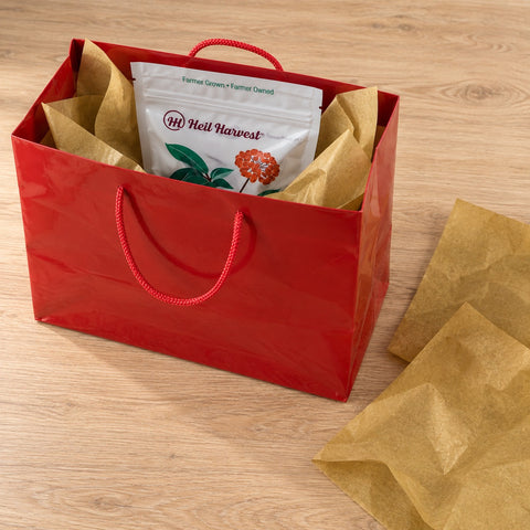 Heil Harvest pouch packed inside the red gift bag with gold tissue
