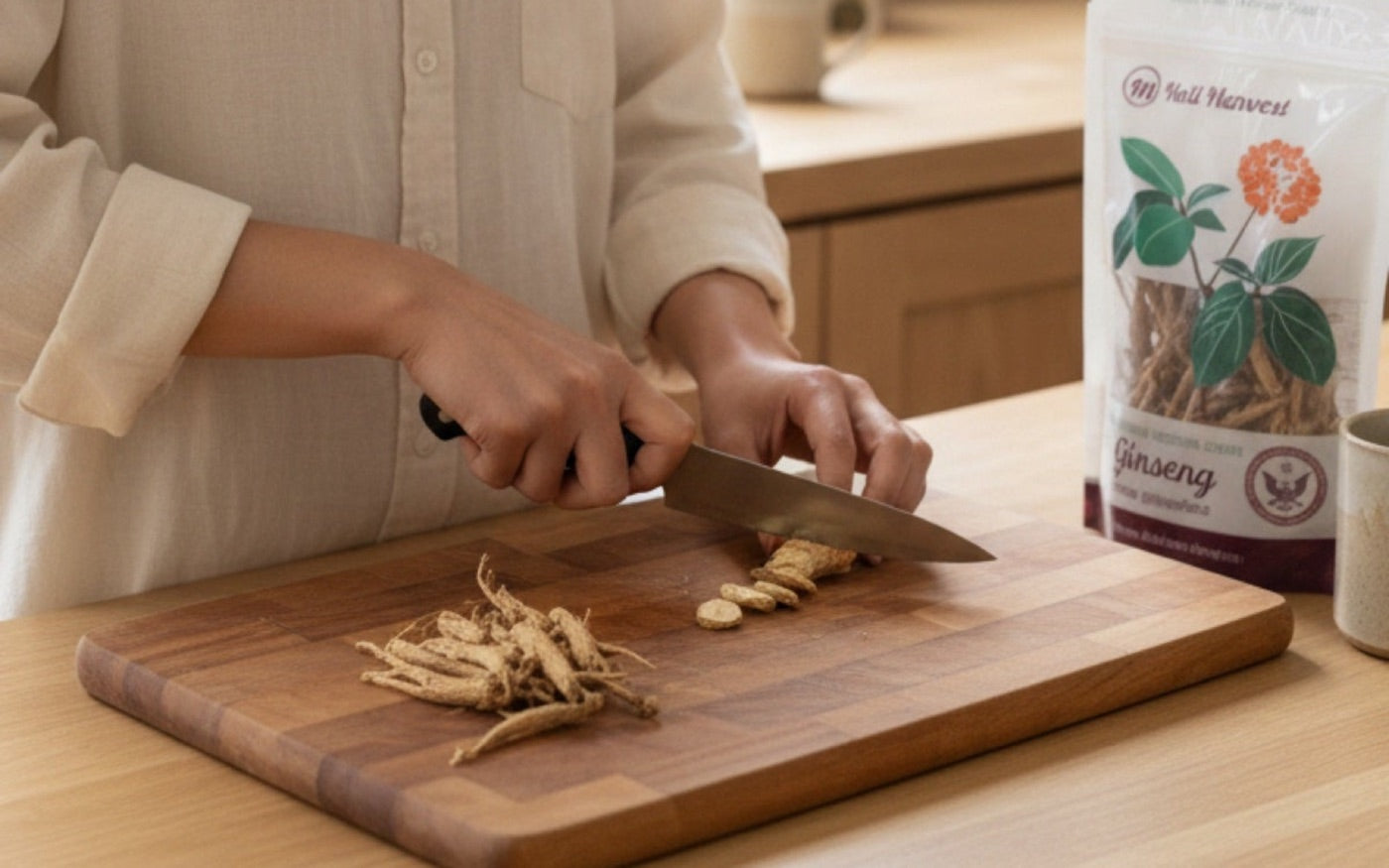 Hands slicing a fresh Wisconsin ginseng root on a kitchen board with a Heil Harvest pouch alongside.