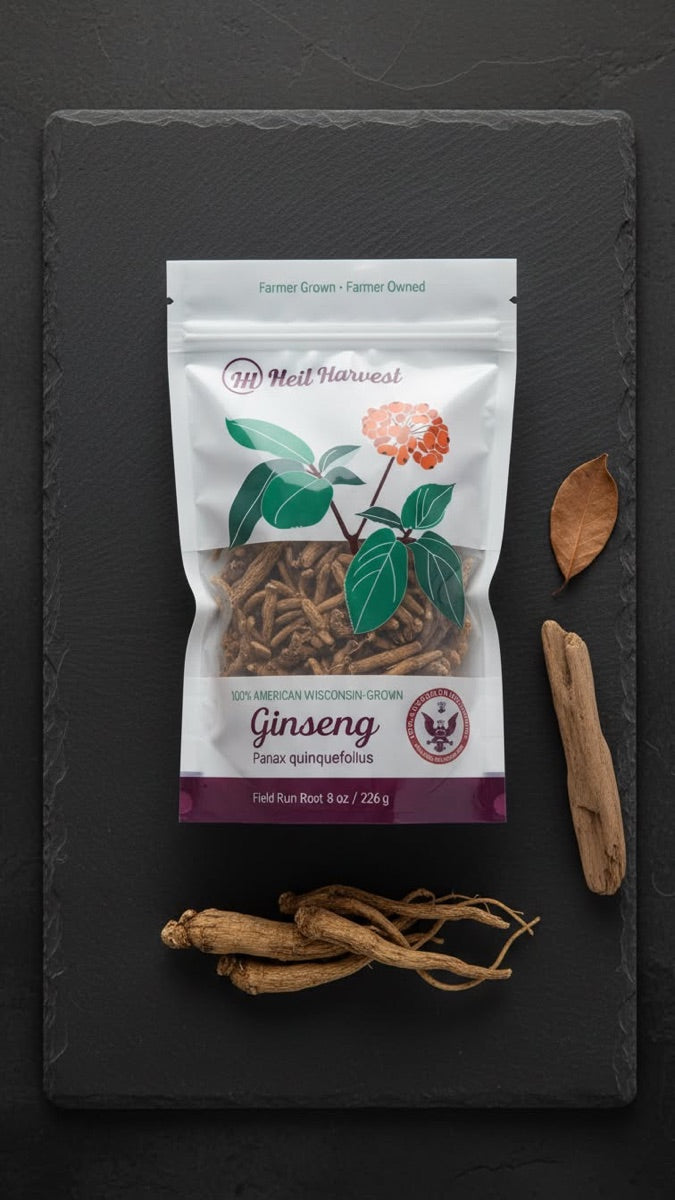 Overhead view of an 8 oz Heil Harvest ginseng pouch with loose whole roots on dark slate.